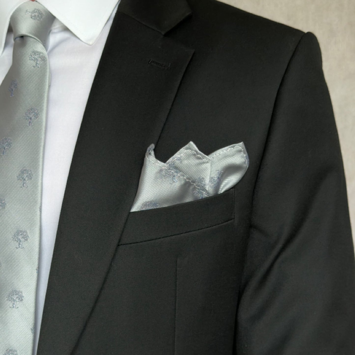 Black suit with grey and white tree embroidered pocket square